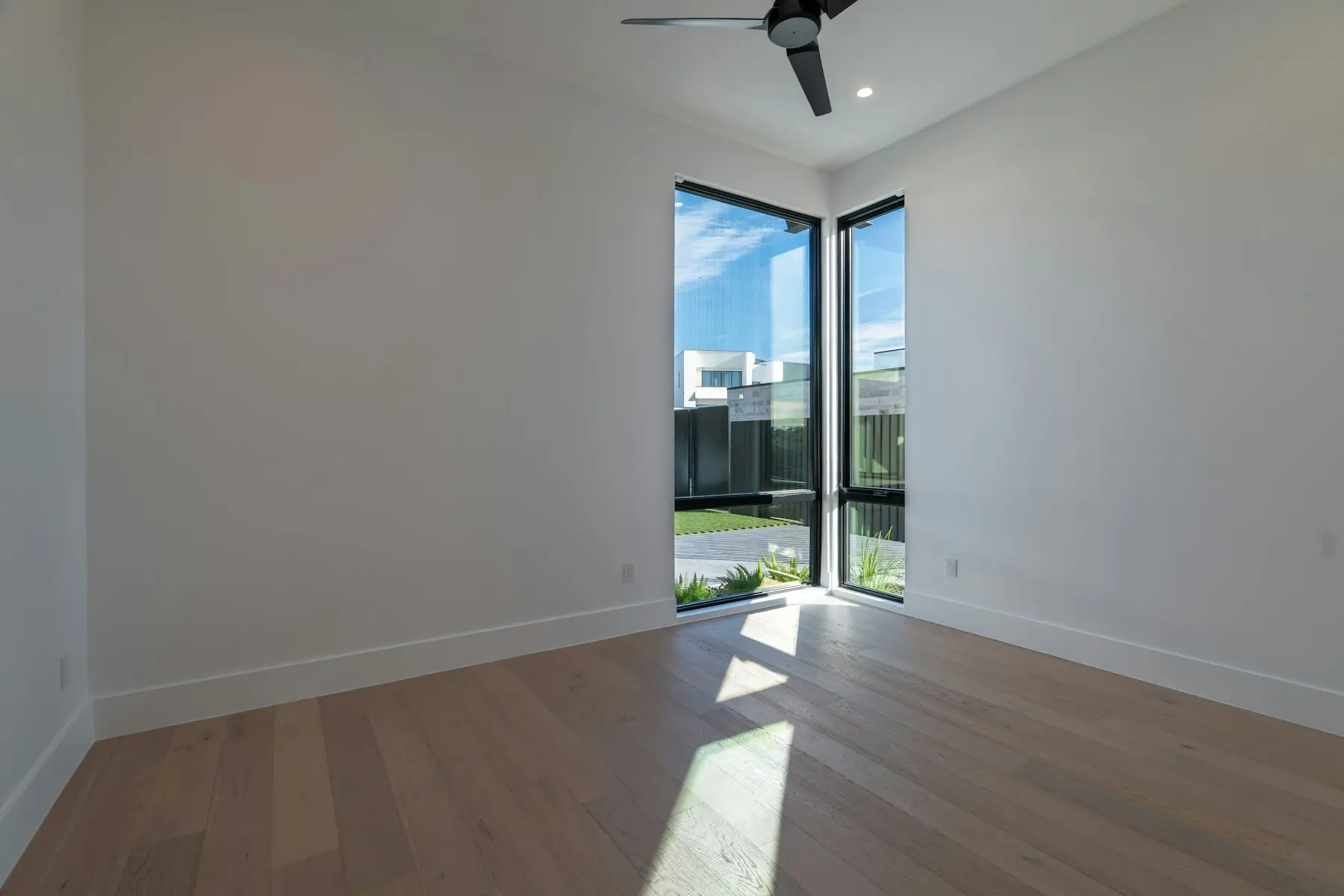 Corner windows over new light oak flooring