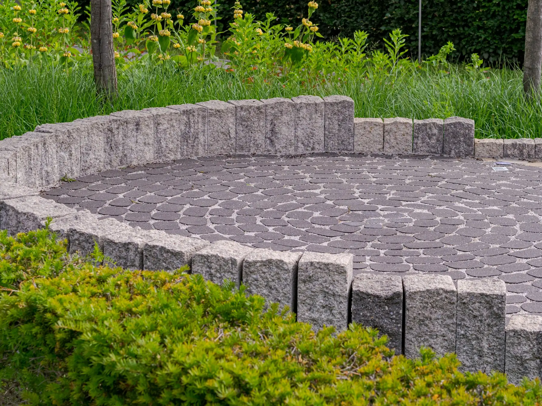 Circular paver patio with a low segmental seat wall